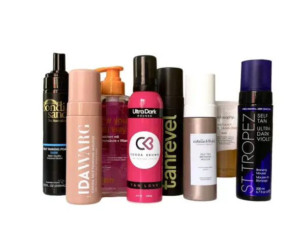 En samling av olika märken av dha brun utan sol-produkter, inklusive mousser och lotions, i olika nyanser.