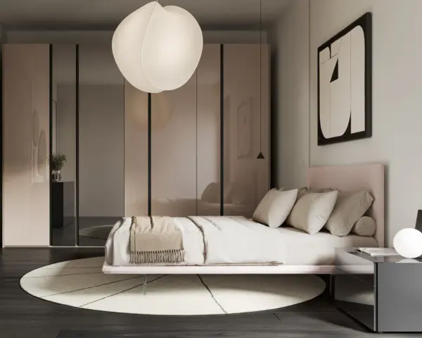 Camera da letto in una casa moderna, con letto rosa, armadio a specchio e lampada a sospensione.