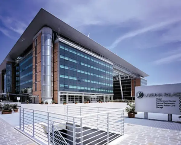 Modern hotel building with glass facade and a sign for Laguna Palace.