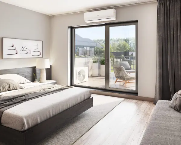 Unidad exterior de aire acondicionado visible a través de la puerta corredera, con una cama y arte de pared en la habitación.
