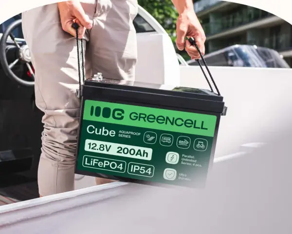 Mężczyzna niesie akumulator LiFePO4 12.8V 200Ah marki Greencell Cube. To jeden z rodzajów akumulatorów, idealny do łodzi, kamperów i wózków golfowych.