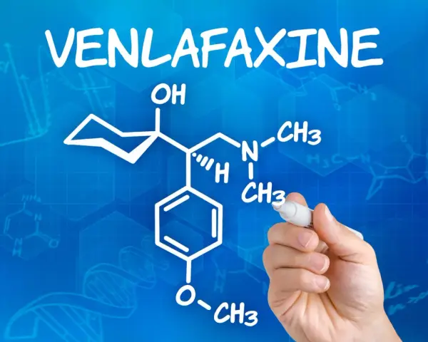 Rysunek chemiczny wenlafaksyny, leku znanego jako velaxin, na niebieskim tle z wzorami chemicznymi.