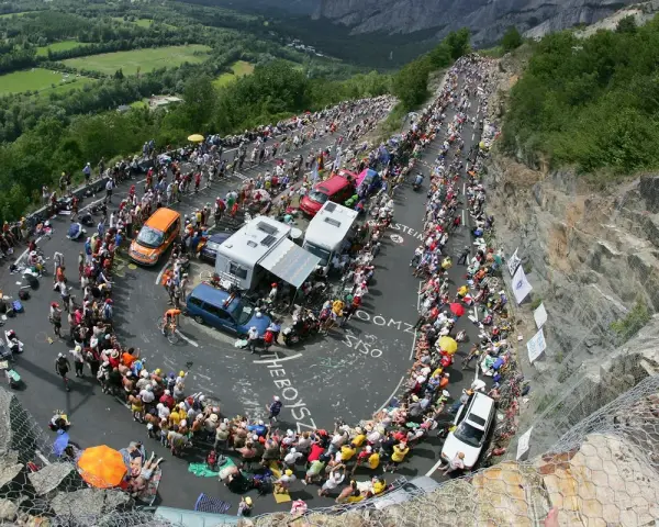 Spectators line the winding road of Alpe d'Huez for the Tour de France, a sea of color and anticipation.