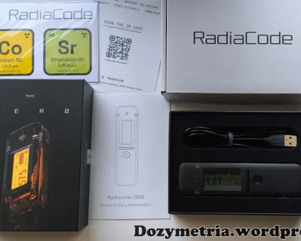 Zestaw Radiacode z dozymetrem ZERO, instrukcją i kablem USB. Obok pudełka z urządzeniem znajduje się karta z informacjami o izotopach Co-60 i Sr-90.