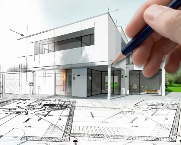 Dłoń trzyma ołówek nad szkicem nowoczesnego domu, który przechodzi w wizualizację. Architekt tworzy marzenie.