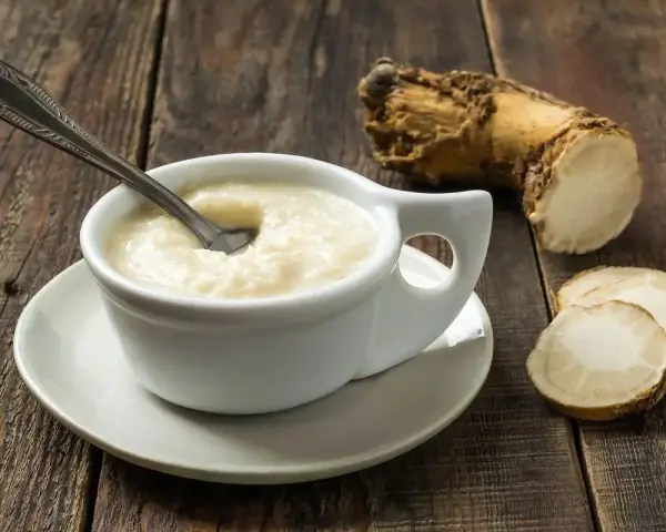 Crema di cren, piccante e saporita, accanto alla radice da cui deriva. Cos'è il cren? È rafano, una radice dal gusto deciso.