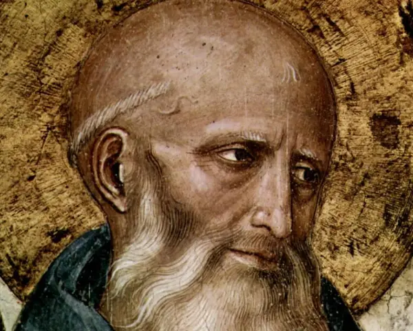 Close-up of St. Benedict the Abbot, a wise elder with a golden halo, his gaze thoughtful.