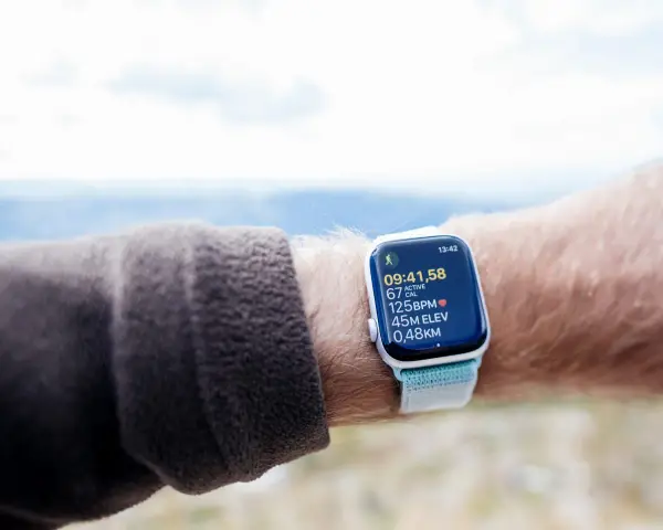 An Apple Watch displays cycling metrics, including time, calories, heart rate, elevation, and distance. It's a great tool for tracking your VO2 max during outdoor activities.