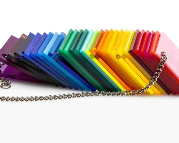 A rainbow fan of acrylic sheets, showcasing varying shades and the material's density, is held together by a silver chain.
