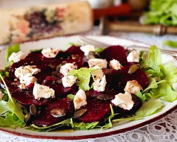 Pyszne carpaccio z buraka z serem feta i pestkami dyni na talerzu.
