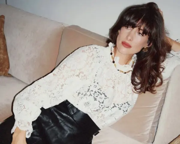 Kobieta w koronkowej bluzce i skórzanych spodniach, uosobienie stylu boho stylizacje.