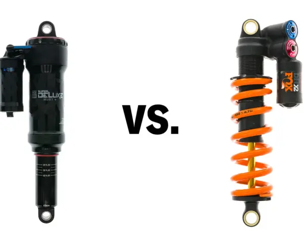 A black air shock and an orange coil shock are shown side-by-side, illustrating the coil vs air shock debate for mountain bikes.