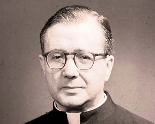 Portrait of a man in clerical attire, wearing glasses. His thoughtful gaze suggests an opus work of God, a life dedicated to faith and service.