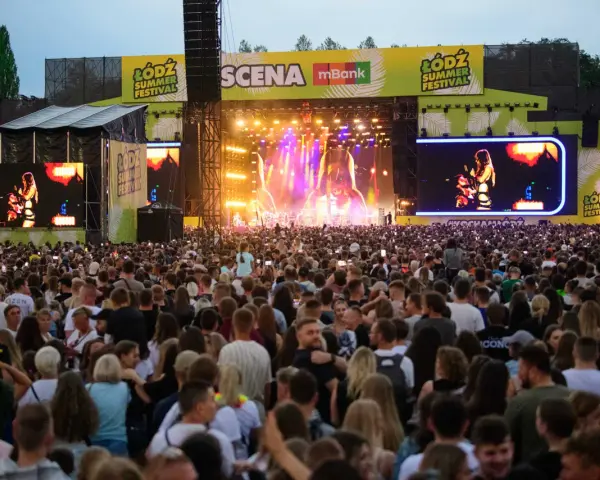 Tłum ludzi na koncercie podczas Łódź Summer Festival. Na scenie artystka, a nad nią wielkie ekrany z jej wizerunkiem.