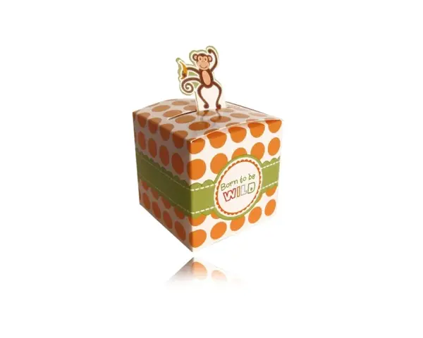 A white gift box with orange polka dots and a green ribbon, topped with a monkey cutout.