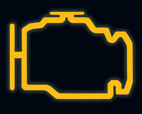 Żółty, migający symbol silnika na ciemnym tle. Czas na wizytę u mechanika, bo to znak, że coś jest nie tak z autem.