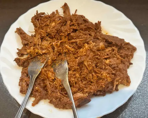 Carne deshebrada jugosa, lista para servir. ¡Perfecta para tu pulled pork receta!