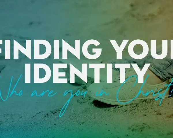 Finding your identity in Christ. A person sits on sand, wearing jeans and sneakers, with text overlay asking "Who are you in Christ?".