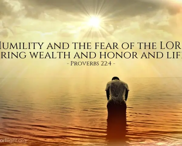 A person kneels in water as the sun shines brightly, illustrating that god lifts up the humble.
