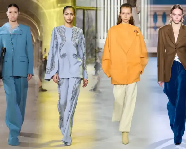 Modelli sfilano con eleganti completi pantalone, un'idea chic per come vestirsi ad un matrimonio con pantaloni.