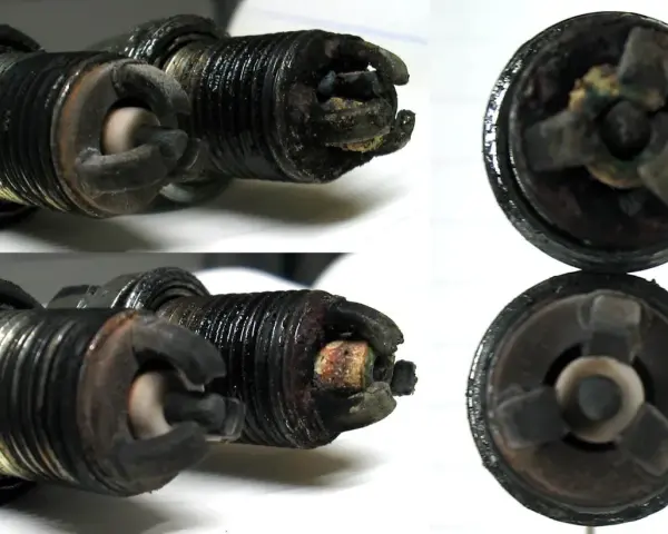 Candele auto sporche e usurate, con depositi carboniosi evidenti. Questi sono chiari sintomi candele da cambiare per un motore efficiente.
