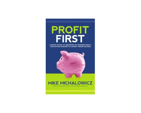 Book cover for "Profit First" by Mike Michalowicz, featuring a pink piggy bank divided into profit-first bookkeeping categories.
