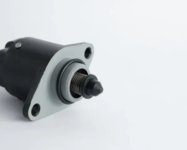 A black and gray idle air control valve, a common cause of rough idling symptoms.