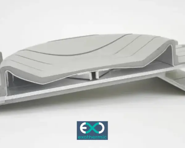 A complex, layered component showcasing advanced forming plastics, with a subtle wave pattern on the top surface.