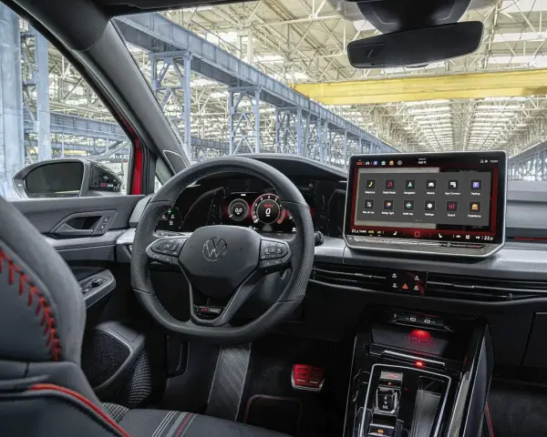 Wnętrze samochodu Volkswagen Golf z dużym ekranem dotykowym i cyfrowymi zegarami.