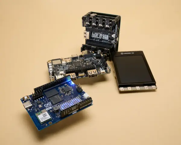 An Arduino Uno, a Bela GEN MULTI, and a Fruit Jam RP2350 board are arranged on a beige surface, showcasing some of the best microcontroller options for makers.