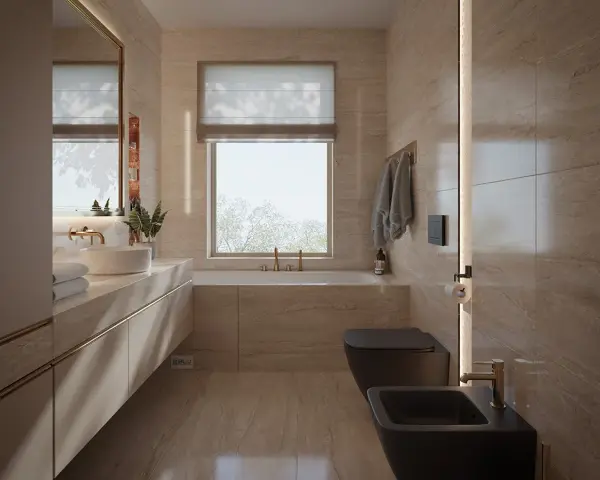 Nowoczesna łazienka z oknem na wprost drzwi, wanna, czarna miska WC i bidet, kamienne płytki, złote baterie.