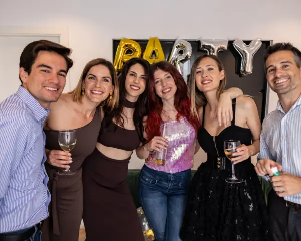 Impreza PRL jak się ubrać? Grupa przyjaciół świętuje, bawiąc się w stylu retro.