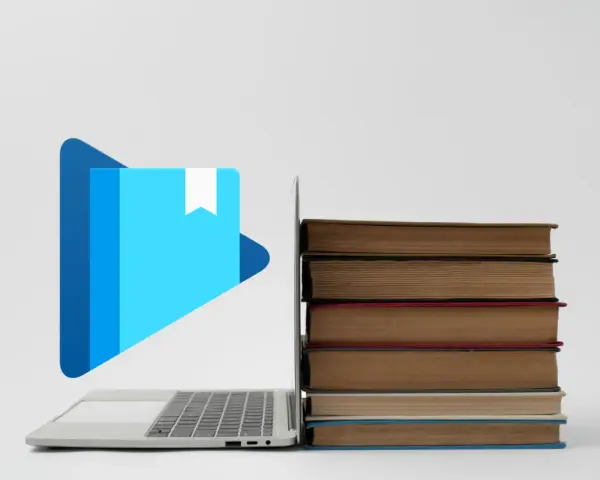 Laptop z ikoną książki i stosem książek. Jak otworzyć plik epub?