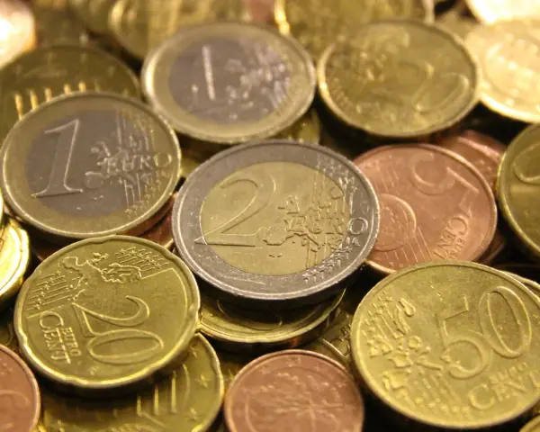 Gros plan sur une pile de pièces en euros de 2002. On distingue des pièces de 1 euro, 2 euros, 20 centimes et 50 centimes.