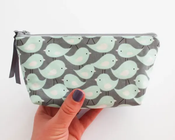 Trousse à maquillage avec motif d'oiseaux, parfaite pour une liste de maquillage pour débutant.