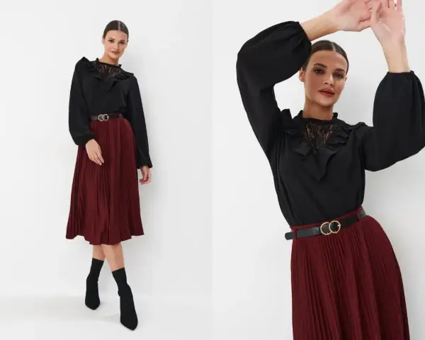 Eleganckie stylizacje damskie: czarna bluzka z koronkowym kołnierzykiem i marszczeniami, bordowa spódnica plisowana, czarny pasek z klamrą.
