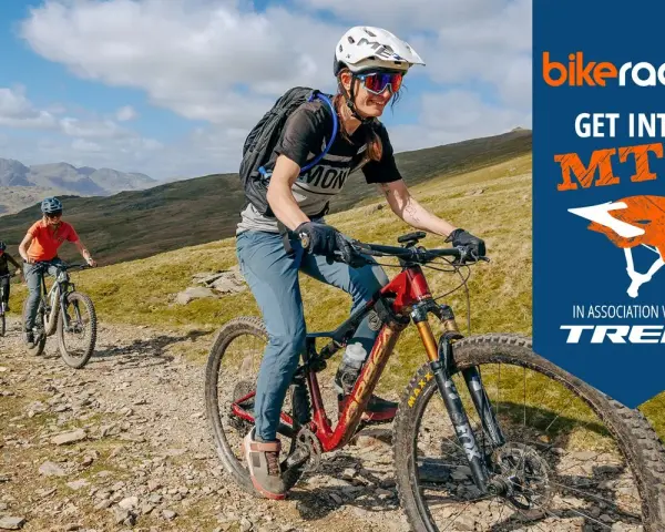 Three friends enjoy a sunny day of cross country biking on a rocky mountain trail, with a "Get Into MTB" logo in the corner.