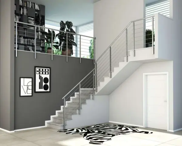 Moderne idee ringhiere scale interne in acciaio inox, con libreria a muro e quadri astratti.