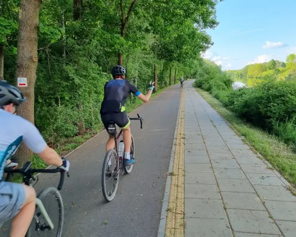 Rowerzyści na malowniczych trasach rowerowych w Warszawie, wzdłuż rzeki.