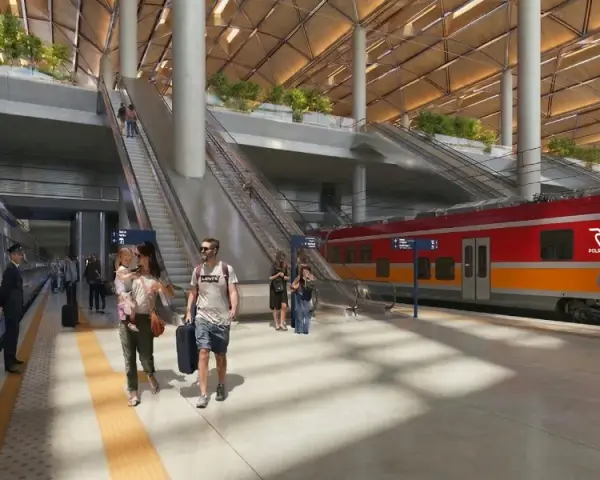 Nowoczesny dworzec kolejowy z pociągiem POLREGIO, pasażerami i schodami ruchomymi.