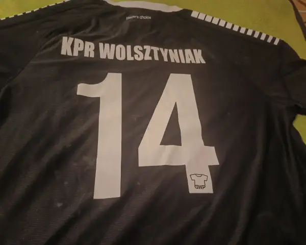 Czarna koszulka z napisem "KPR Wolsztyniak" i numerem 14.