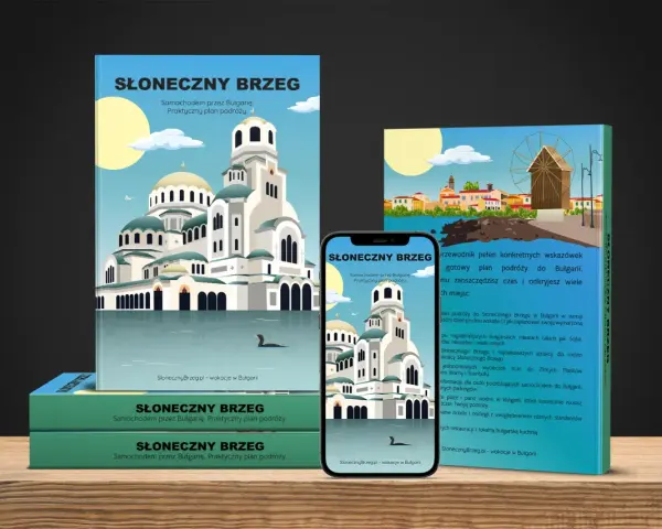 Okładki przewodników i smartfon z widokiem na cerkiew i plażę.