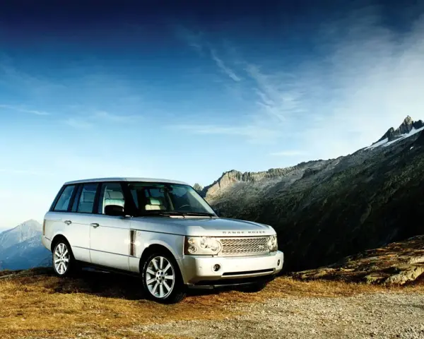Srebrny Range Rover Vogue na tle górskich szczytów. Gotowy na każdą przygodę.
