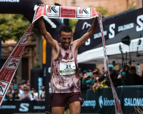 Corredor celebra su victoria en la **Zegama-Aizkorri** rompiendo una cinta.