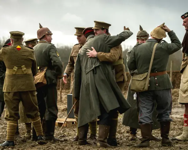 Des soldats en uniforme s'embrassent, une scène évoquant la trêve de Noël 1914.
