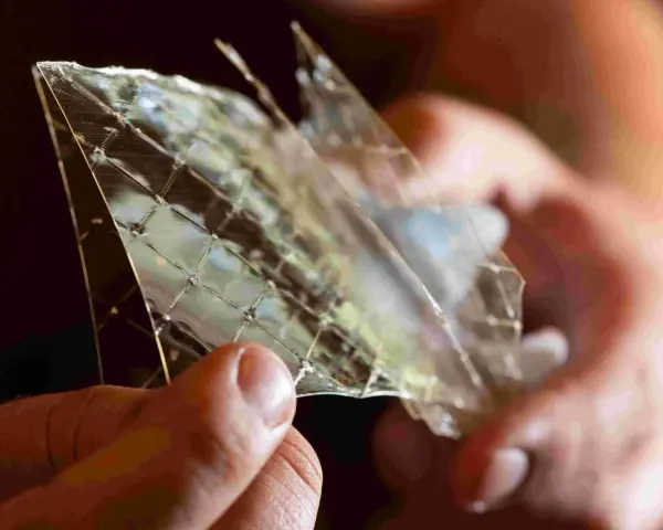 Hände halten ein Stück Gelatine, das wie Glas zerbrochen ist. Die feinen Linien zeigen die vielfältige Gelatine Verwendung in der Küche.