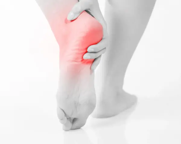 A person's foot with a red highlight on the heel, suggesting pain. This image evokes the relief of soaking an ankle in epsom salt.
