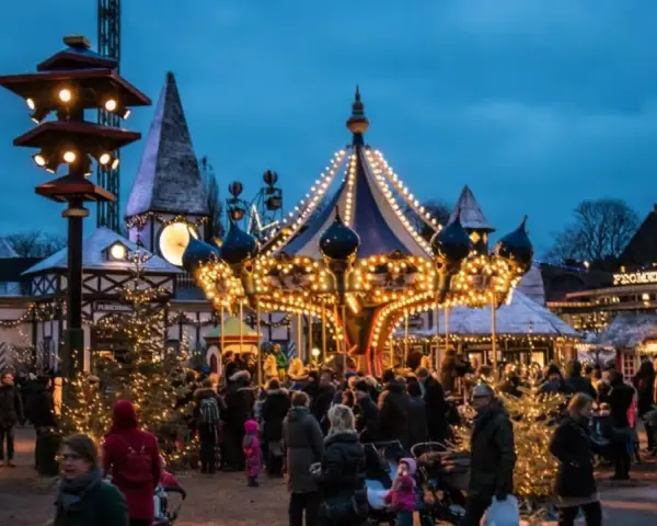 A lively Copenhagen Christmas market at dusk, with a brightly lit carousel and festive stalls. People stroll amongst decorated trees, enjoying the magical atmosphere.