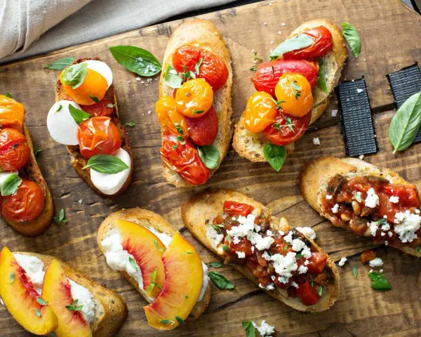 Letnia uczta: bruschetty z pomidorkami i mozzarellą, brzoskwiniami i fetą, a także z warzywnym ragout. Idealne co na grilla!
