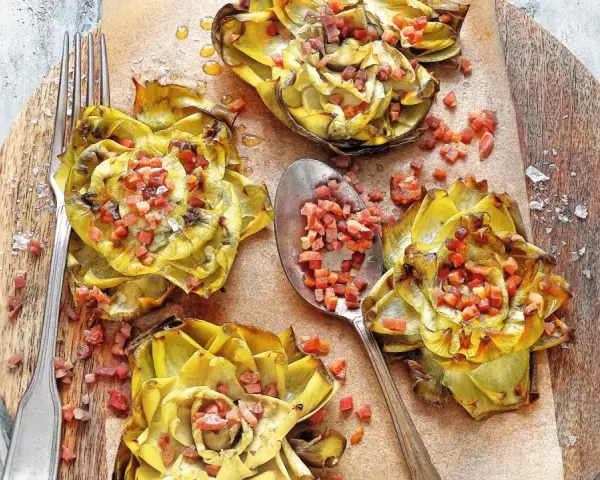 Deliciosas alcachofas al horno, doradas y rellenas de trocitos de jamón, listas para disfrutar.